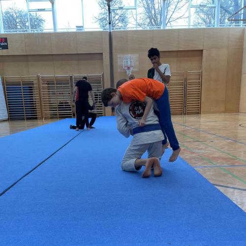 Schüler und Trainer beim Trainieren am Boden