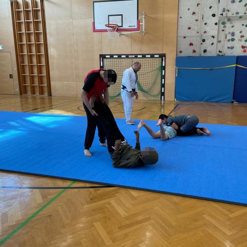 Schüler und Trainer beim Trainieren am Boden